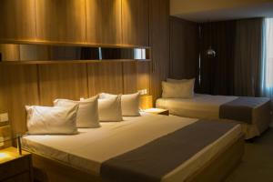 Nobile Hotel Convention Ciudad Del Este tesisinde bir odada yatak veya yataklar