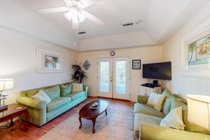 a living room with a couch and a table at Sand Quarters in Edisto Beach