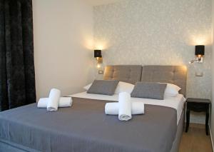 a bedroom with two beds with white towels on them at Apartment Tonka in Šibenik