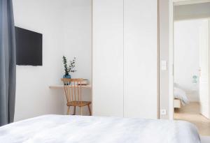 ein Schlafzimmer mit einem Bett, einem Tisch und einem Stuhl in der Unterkunft KOSI am Meer ZEHN in Ostseebad Koserow