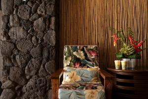 a chair sitting next to a stone wall at White Sands Hotel in Honolulu