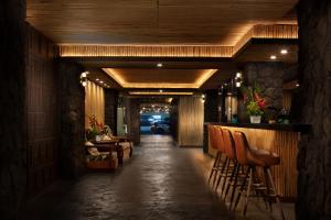 a hallway with chairs and a bar in a restaurant at White Sands Hotel in Honolulu
