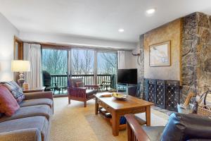 a living room with a couch and a fireplace at White Ridge B2 in Teton Village