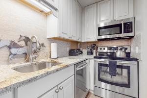 a kitchen with a sink and a microwave at White Ridge B2 in Teton Village