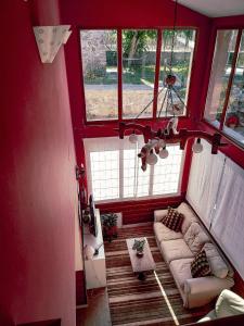 a living room with a couch and two windows at Hotel rural La Campanona in Villager de Laciana