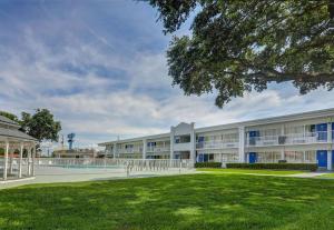 an exterior view of a building with a yard at Motel 6-Jacksonville, NC in Jacksonville