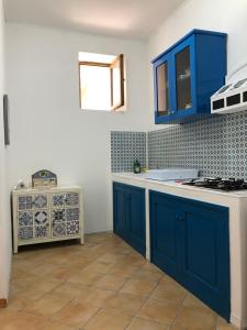 a kitchen with blue cabinets and a counter top at Il Cortiletto - Lipari CENTRO in Lipari
