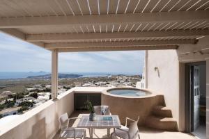 a balcony with a table and a swimming pool at Kastro Mansion in Pyrgos