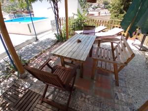 a wooden table and chairs on a patio at Casa Cueva “La Estrella” in Granada