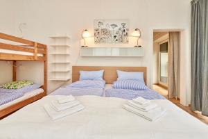 two beds in a small room with towels on them at Payerbach Apartments in Payerbach