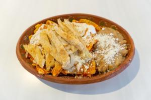 a bowl of food with chips and cheese at Hotel America Centro in Los Mochis