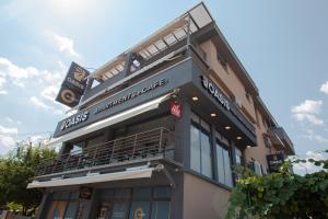 a building with a sign on the side of it at OASIS Apartments in Gevgelija