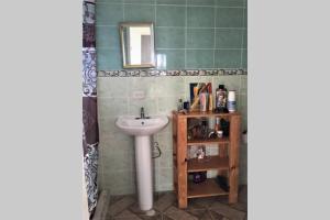 a bathroom with a sink and a mirror and a shelf at CASA VACACIONAL DE PLAYA in Nueva Gorgona +26 photos
