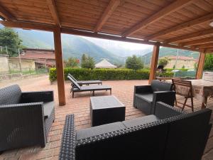 a patio with chairs and a table and a table and a table at La Ciuenda in Perosa Argentina