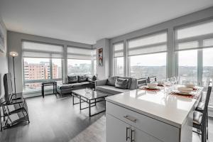 a kitchen and living room with a couch and a table at Capitol Hill Fully Furnished Apartments in Washington, D.C.