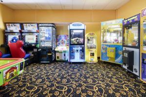 a arcade with four arcade games in a room at Top of the Town Hotel Motel in Burnie