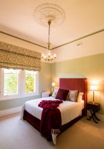 A bed or beds in a room at Kyneton Manor House