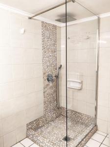 a shower with a glass door in a bathroom at Family house by the seaside of Karavostasis in Karavostasi