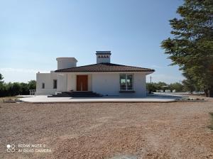 a small white building with a tower on top at Tenuta Bardi in Villa Baldassarri