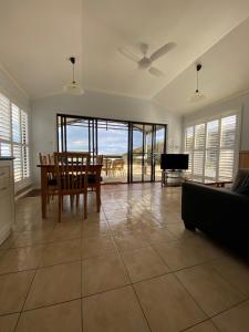 a living room with a table and a couch at Tuross Beach Cabins & Campsites in Tuross Heads