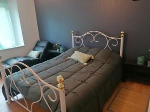 a bed and a chair in a bedroom at Gîte le parc Michel in Roz-sur-Couesnon