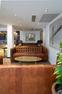 a living room filled with furniture and a large window at Hotel Artmadams in Palma de Mallorca