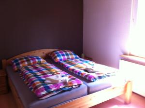 a bed with two pillows on it in a room at Jeanny´s Ferienwohnung in Thale