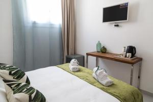 Postel nebo postele na pokoji v ubytování Family Green Suite