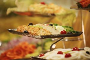 a plate of food on a table with desserts at De Vivendi Resorts, Manali with 35000 Sqft Open Lawn in Manāli