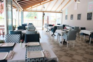 a dining room with tables and chairs and windows at Casablanca Hotel in Dalyan