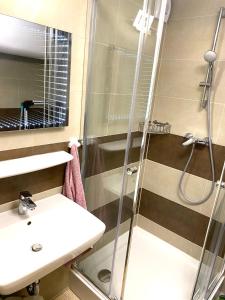 a bathroom with a shower and a sink at Silver Gellért Apartman in Siófok