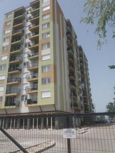 a tall building with a sign in front of it at Silver Gellért Apartman in Siófok