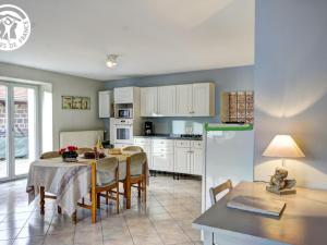 a kitchen and dining room with a table and chairs at Studio Planfoy, 1 pièce, 2 personnes - FR-1-496-134 in Planfoy