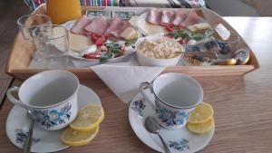 a table with two cups and a tray of food at U Wiesi in Poronin