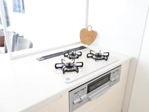 a kitchen counter with a stove top oven at サンライン北谷コンドミニアムリゾート in Chatan +42 photos