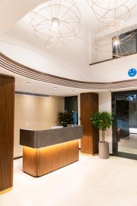 an office lobby with a reception desk and potted plants at MEG HOTEL in Istanbul