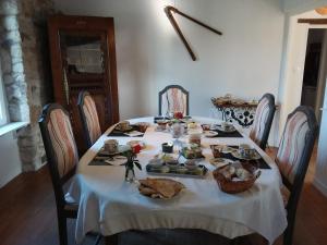 a table with a white table cloth and food on it at Les chambres de Marie in Le Saint