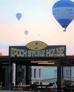 a hot air balloon is flying over a restaurant at Epoch Stone House in Goreme