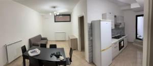 a kitchen and dining room with a table and a refrigerator at Accanto all'autostrada al centro tra Roma e Napoli in Pontecorvo