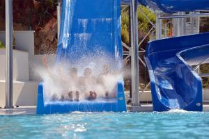 a pool of water with a blue and white foam roller coaster at Garcia Resort & Spa - Ultra All Inclusive in Oludeniz