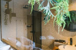 a bathroom with a shower and a sink at SoHotel in Schagen