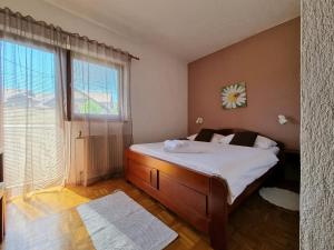 a bedroom with a bed and a window at House Hodak in Grabovac