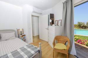 a bedroom with a bed and a balcony with a pool at Like-home-T2 house, pool, AC, garden in Ericeira +18 photos
