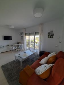 a living room with a couch and a table at Dunas de Corrubedo in Ribeira