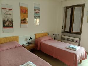 Postel nebo postele na pokoji v ubytování Albergo Roma + 37 fotografií
