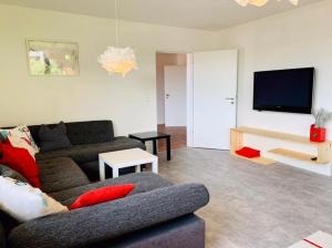 a living room with a couch and a flat screen tv at Ferienwohnung JoSi in Kappelrodeck