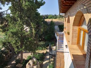 a view from the balcony of a house with a tree at Casa Rural Boletas in Loporzano
