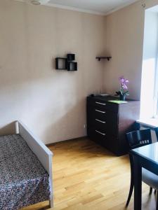 a bedroom with a bed and a dresser and a desk at Quite center of Riga in Rīga
