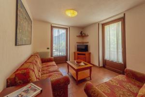 a living room with a couch and a table at Chalet Pontal 6 in Courmayeur