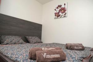 a bedroom with a bed with towels on it at VINEA PANONIKA wine & mind retreat in Radenci